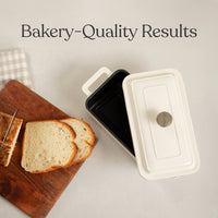 Sliced white loaf on a board next to the black enamel interior of the loaf oven: bakery-quality results