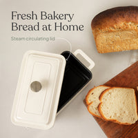 Loaf bread oven with its steam-circulating lid beside a sliced sandwich loaf