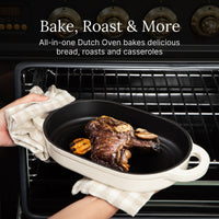Oval bread oven used as a roaster with a steak, being lifted from the oven