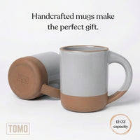 Dove Grey mug on its side with a 12 oz capacity callout