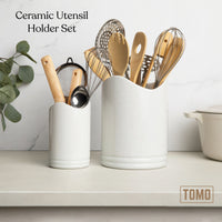 Ceramic utensil holder set on a kitchen counter filled with wooden utensils and a whisk