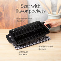 Hands holding the pre-seasoned shrimp pan showing its 22 flavor pockets