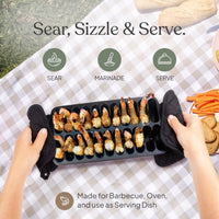 Shrimp grill pan full of cooked shrimp being served at an outdoor picnic table