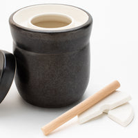 7L crock with lid removed showing the water channel, wooden tamper and two half-moon weights