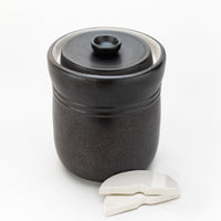 TOMO 7L fermentation crock with lid and two half-moon ceramic weights on a white background